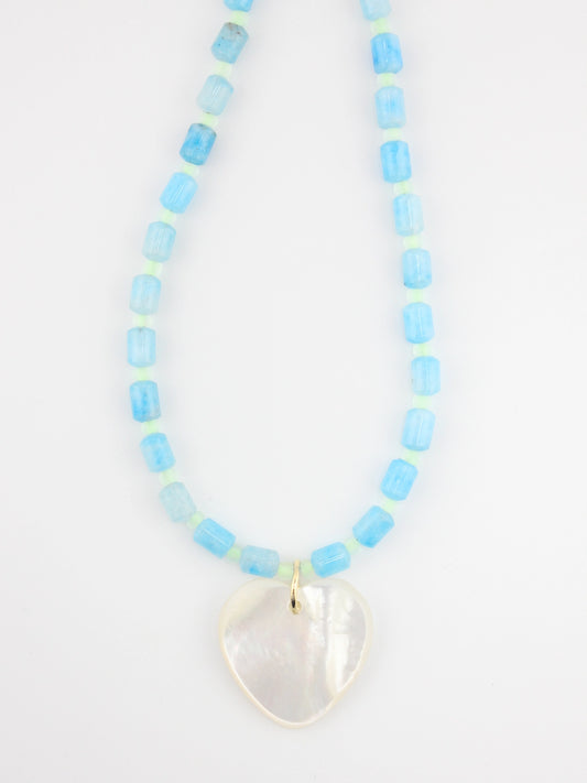Necklace with light blue beads and a heart-shaped pendant on a white background