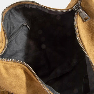 Close-up of an open tan suede or faux-suede bag showing a black interior lining with a zippered pocket and silver-tone zipper hardware.