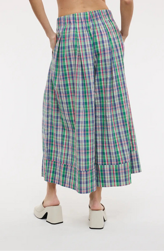 Person wearing a plaid skirt on a white background
