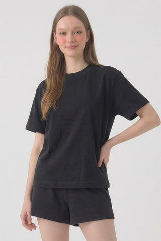 Person wearing a black t-shirt and shorts set on a white background