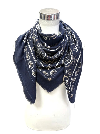 A navy bandana scarf with a black and white paisley pattern, draped on a white mannequin torso against a white background.