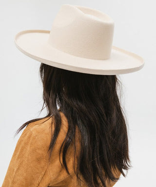 a person wearing a white large brim hat