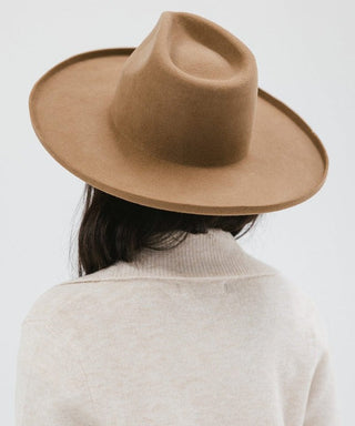 a women wearing a brown fedora hat