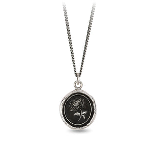 Necklace with a round pendant featuring a black and white design on a white background