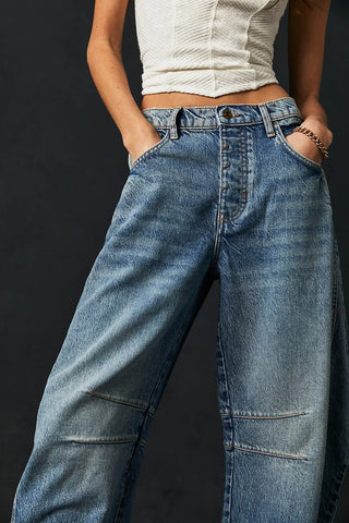 women wearing blue free people barrel jeans