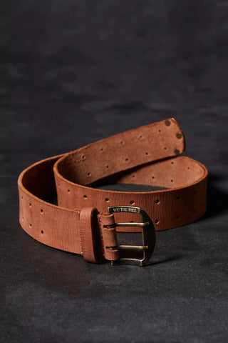 Brown leather belt with a gold buckle on a dark background