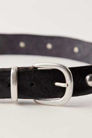 Black leather belt with silver buckle on a light gray background