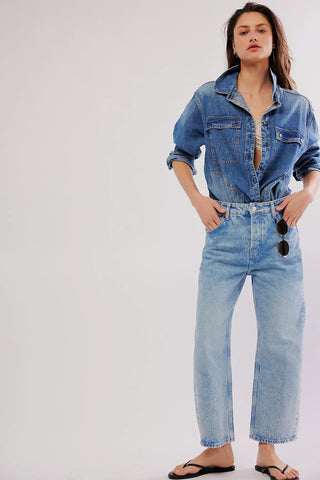Woman wearing a denim outfit with a white background