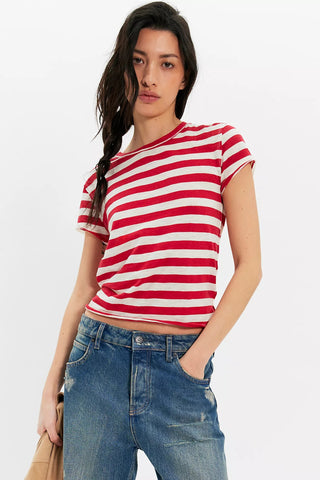 Woman wearing a red and white striped shirt with blue jeans on a white background