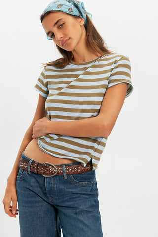 Woman wearing a striped shirt and jeans with a plain background