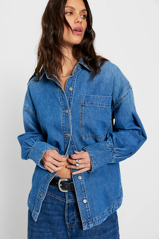 Woman wearing a blue denim shirt on a white background