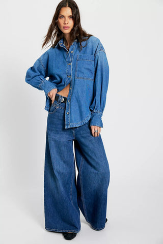 Woman wearing a blue denim outfit on a white background