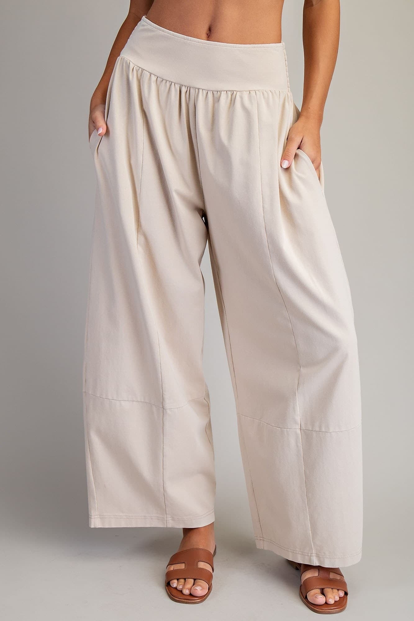 Beige wide-leg pants worn by a person on a plain background