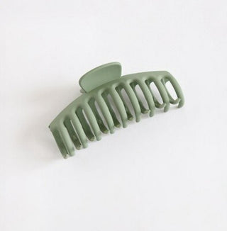 a plastic claw clip in a green colour