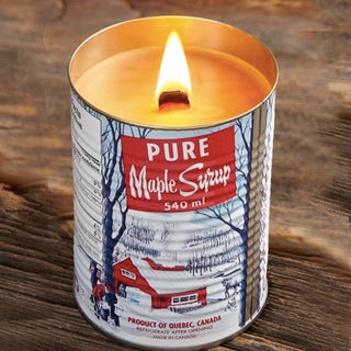 Candle inside a can labeled 'Pure Maple Syrup' on a wooden surface