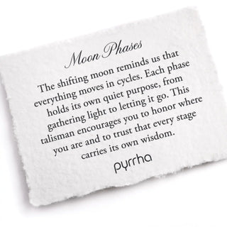 White stone with engraved text about moon phases and pyrrha branding