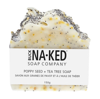 Bar of soap with visible poppy seeds and tea tree oil droplets, branded as Buck Naked Soap Company.