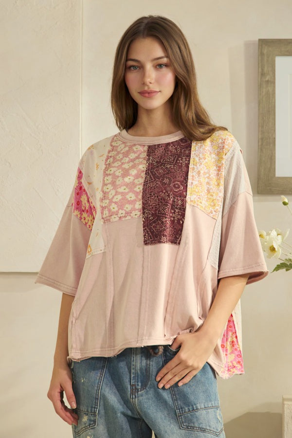 Woman wearing a patterned top with a neutral background