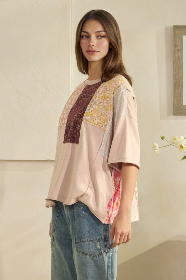 Woman wearing a colorful blouse with a neutral background