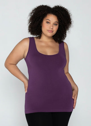 Woman wearing a purple tank top against a plain background
