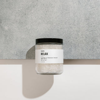 Jar of bath salts labeled 'Relax' on a neutral background