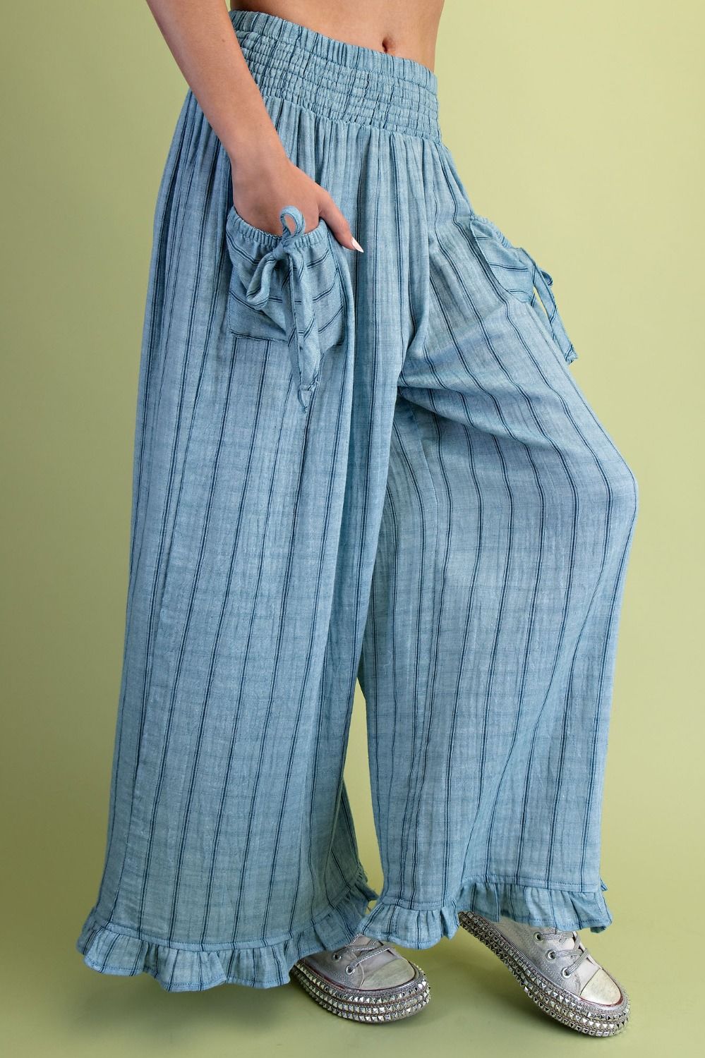 Blue checkered pants with ruffled details on a green background