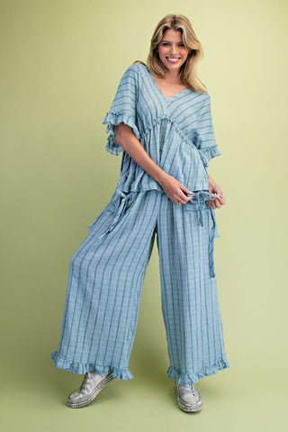 Woman wearing a blue striped outfit on a green background