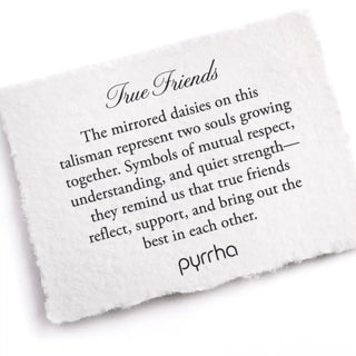 White stone with engraved text about true friends and pyrrha brand