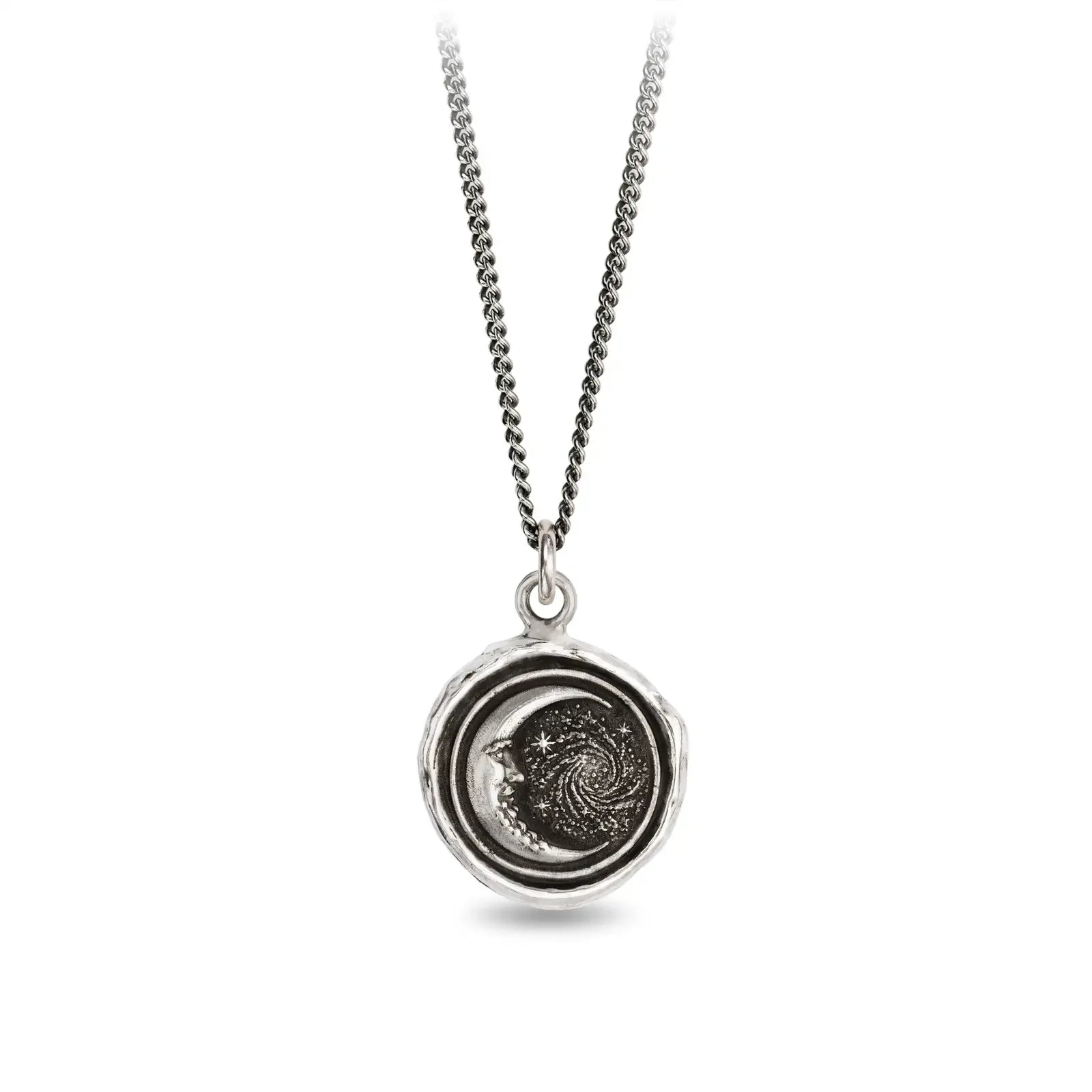 Silver necklace with a circular pendant featuring celestial design on a white background