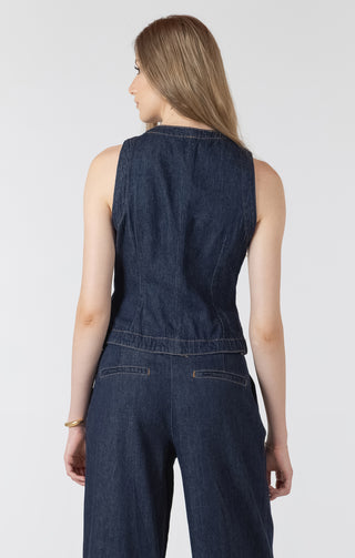 Woman wearing a dark denim jumpsuit on a white background