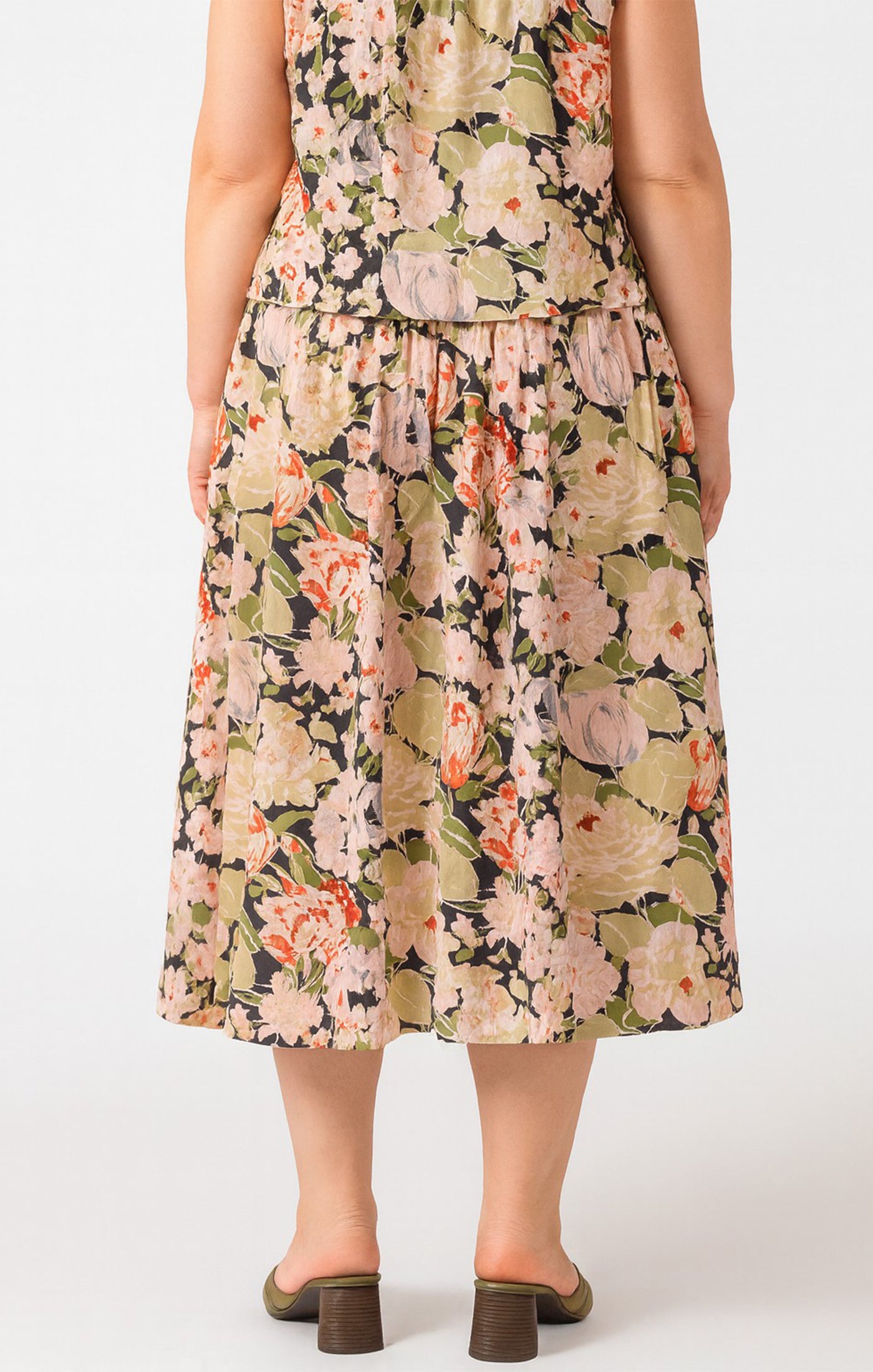 Woman wearing a floral dress on a white background