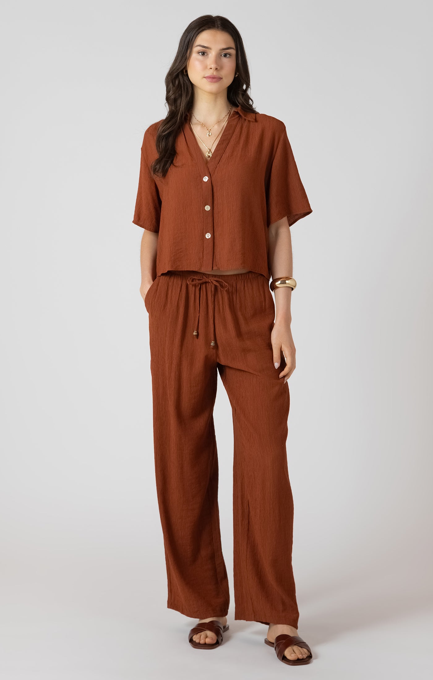 Woman wearing a brown outfit on a white background