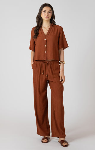 Woman wearing a brown outfit on a white background
