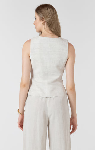Woman wearing a light gray sleeveless top and pants on a white background