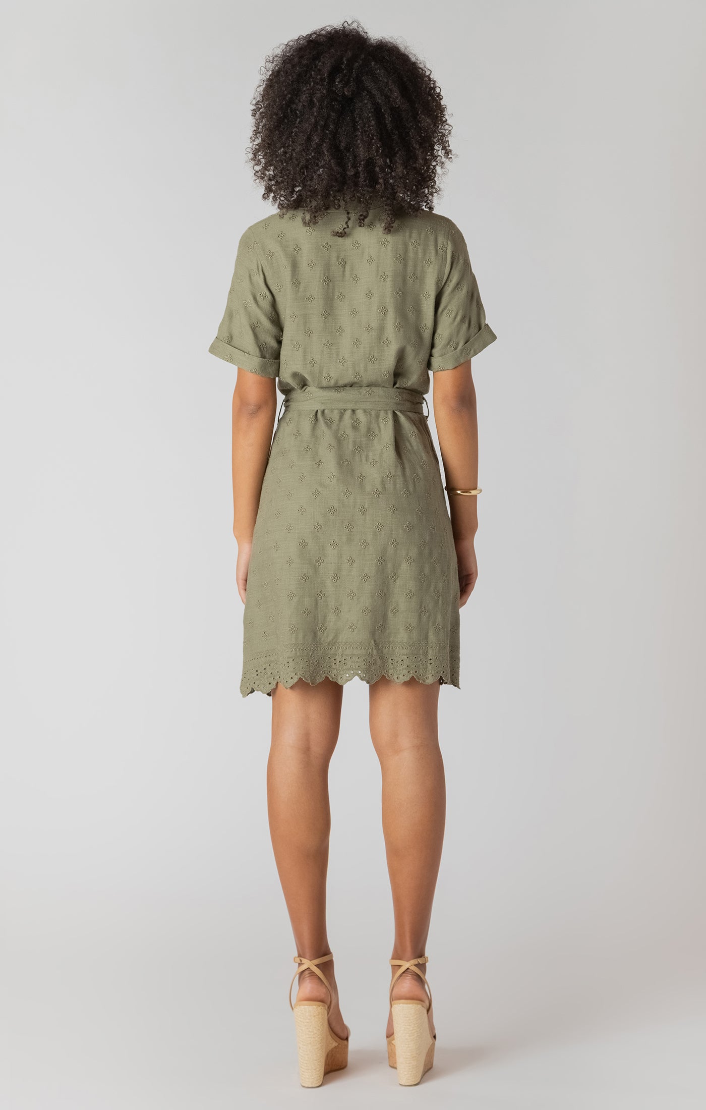 Person wearing a green dress on a white background