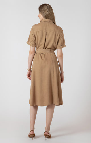 Woman wearing a beige dress with a belt on a white background