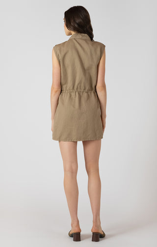Woman wearing a beige sleeveless romper on a white background