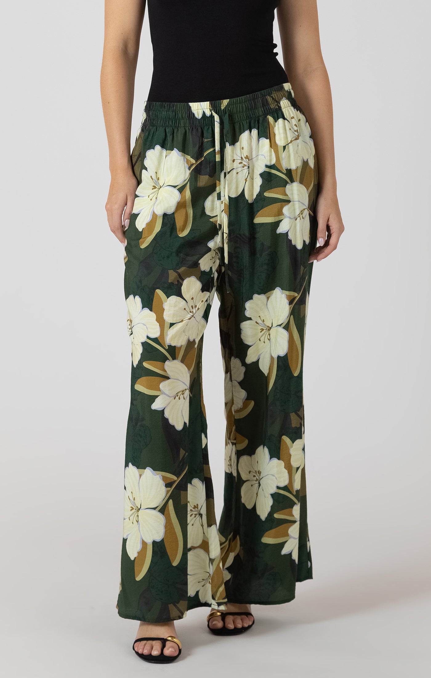 Floral-patterned pants worn by a person on a plain background