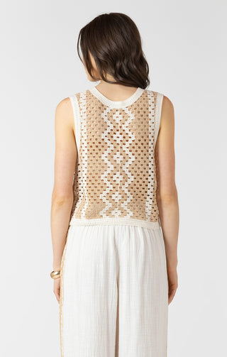 Woman wearing a sleeveless dress with a geometric pattern on a white background