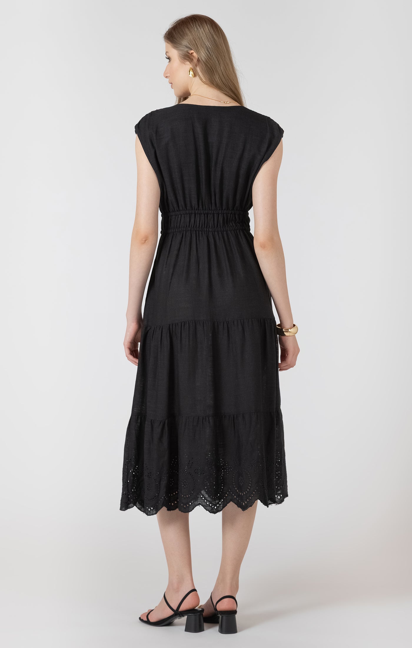 Woman wearing a black dress with a white background