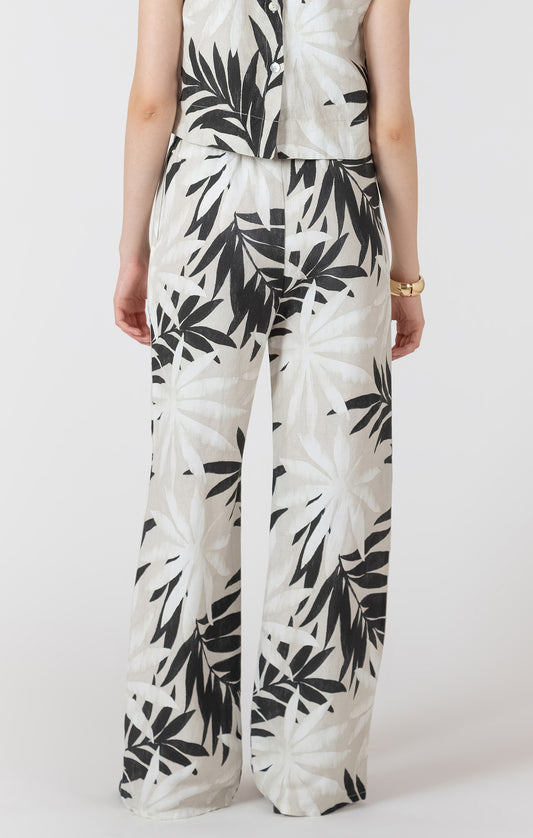 Person wearing a white outfit with black leaf pattern on a white background