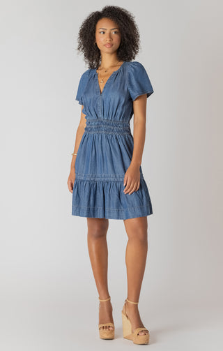 Woman wearing a blue dress on a white background