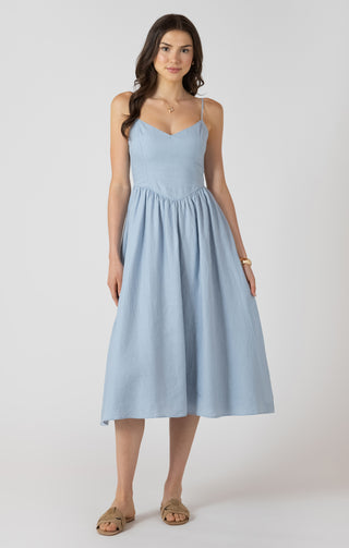 Woman wearing a light blue dress on a white background