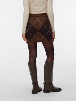 Women modelling a brown knit skirt with tall high black boots and tights. 