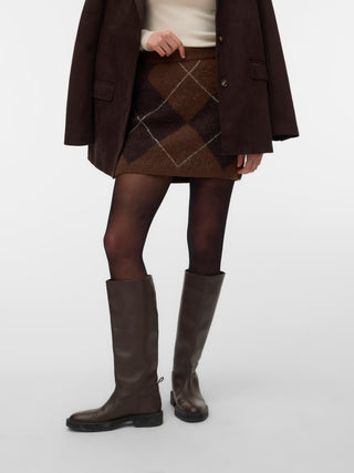 Women modelling a brown knit skirt with tall high black boots and tights. 