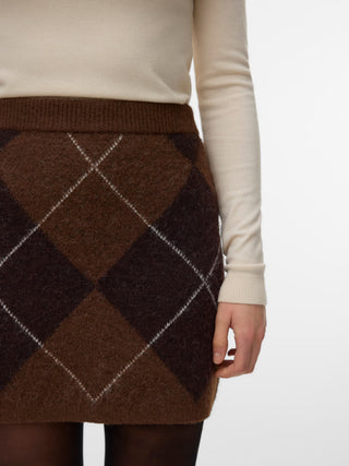 Women modelling a brown knit skirt with tall high black boots and tights. 