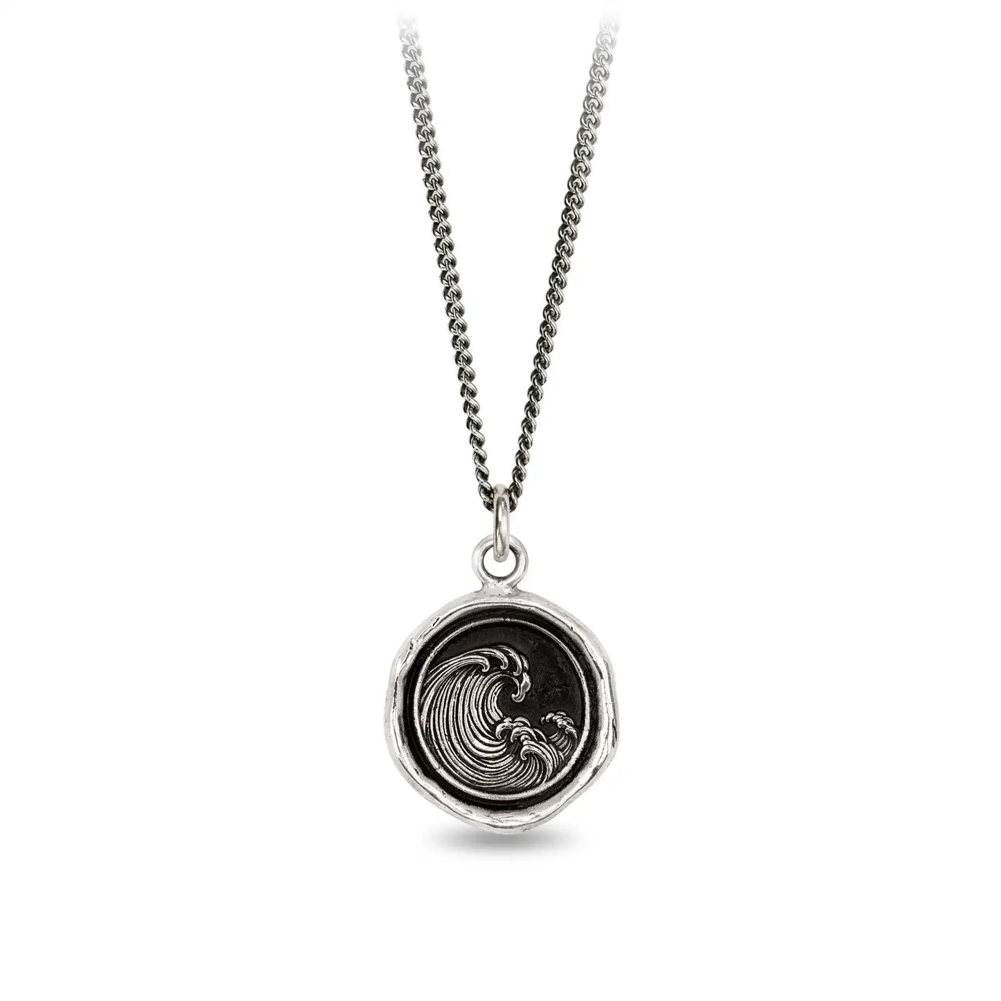 Silver necklace with a round pendant featuring a wave design on a white background