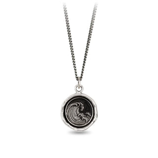 Silver necklace with a round pendant featuring a wave design on a white background