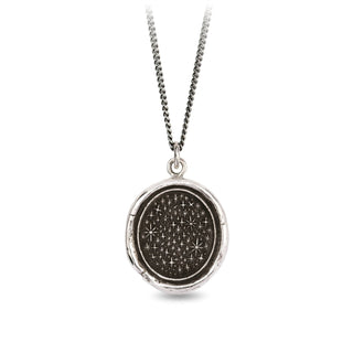 A sterling silver necklace with a circular talisman featuring a pattern of stars on a chain, fastening with a sterling silver lobster clasp.
