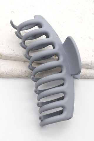 a plastic claw clip in a grey colour